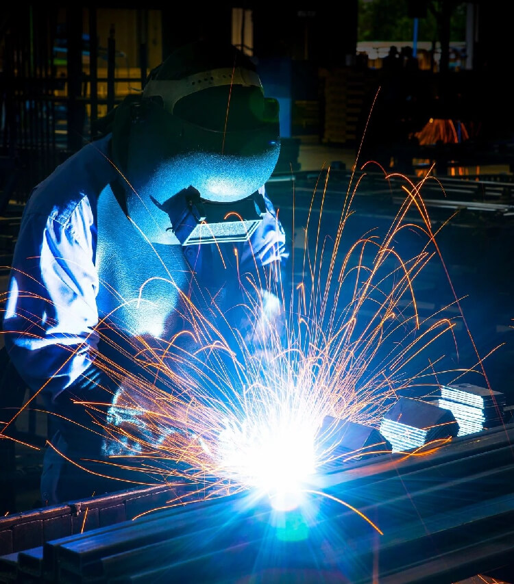 During the creation of metal equipment, the welder utilises a flame to create sparks.